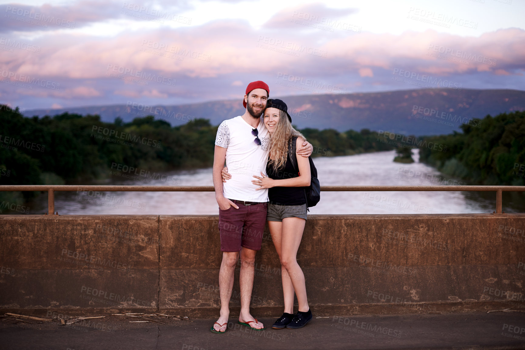 Buy stock photo Travel, couple and portrait on bridge together for holiday adventure, weekend vacation or getaway trip. Tourist, people and happy in countryside for exploration, sightseeing nature or relax with love