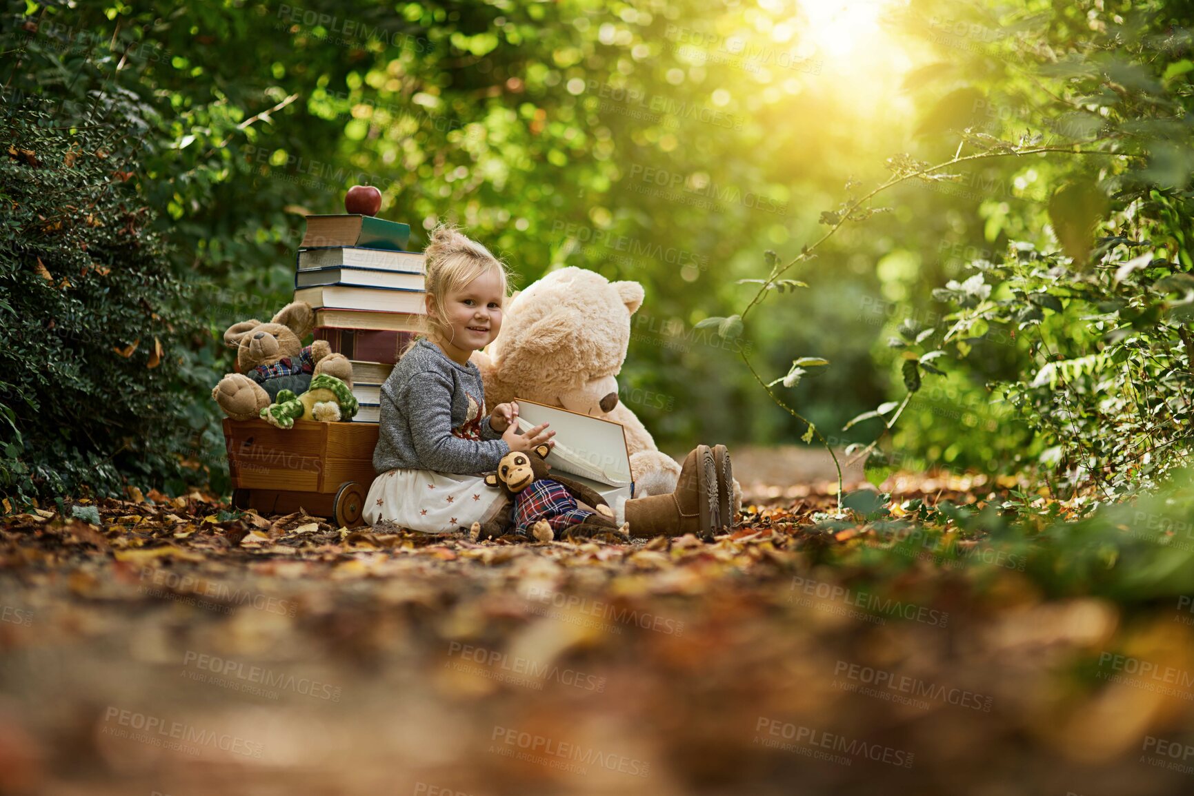 Buy stock photo Learning, portrait and girl reading book in forest with teddy bear, toys or child development in nature. Happy, literacy and kid in park with fantasy, fairytale or peace in woods for education hobby