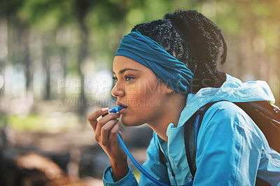 Buy stock photo Woman, trail runner and drinking water in woods with straw, backpack or break for hydration in nature. Girl, person and forest with beverage, tired or reflection for progress with hiking in Colombia