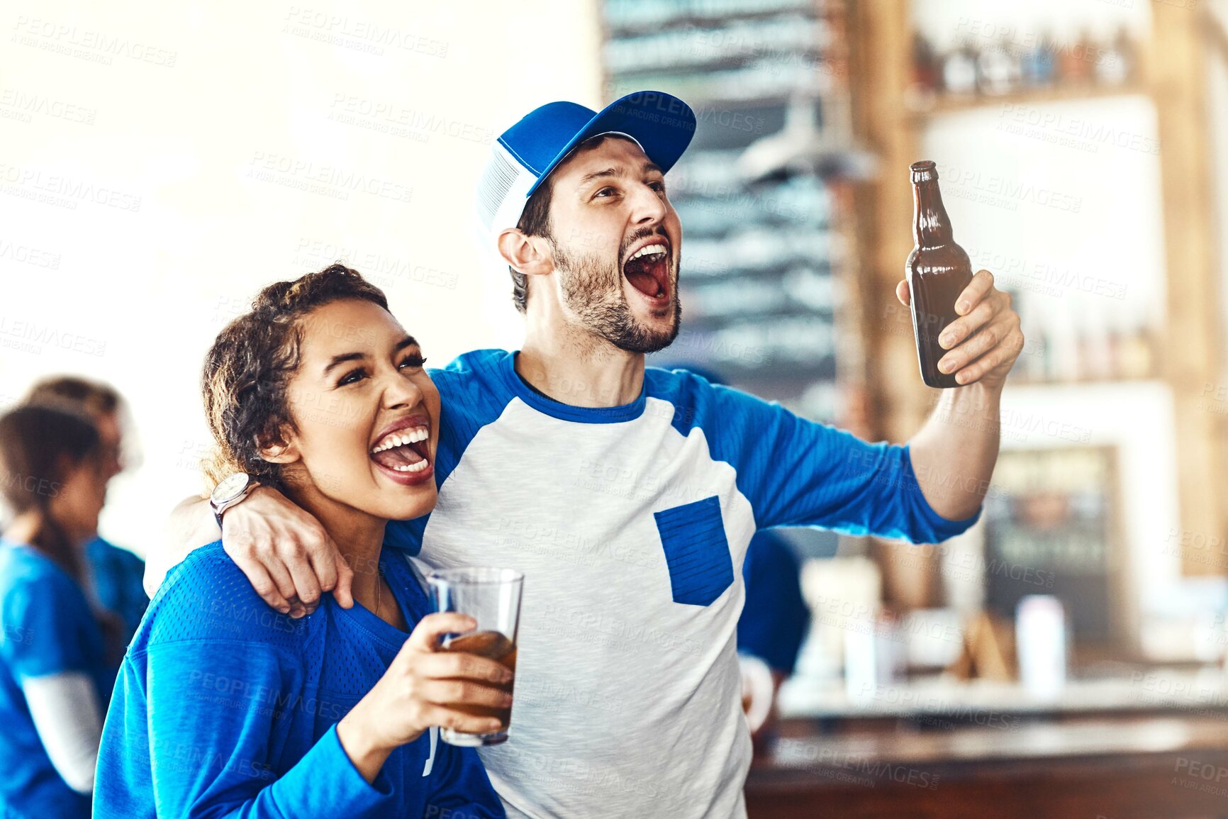 Buy stock photo Sports, goal or couple in pub with alcohol, smile or celebration of competition, winning or score. Excited, soccer game or people in bar for watch party, beer drinks or fans at diner for happy hour