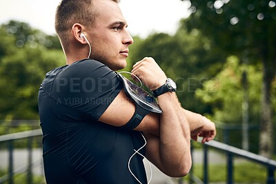 Buy stock photo Outdoor, stretching and man with fitness, workout and energy for warm up, challenge and healthy. Person in park, podcast or runner with exercise, listening to music or training with wellness or radio