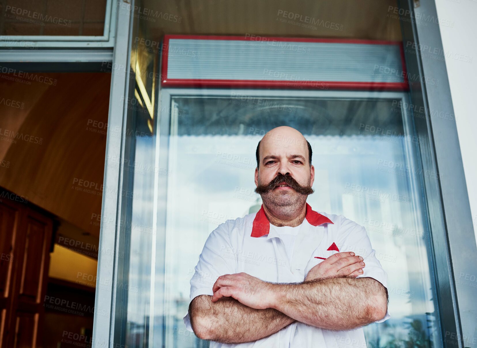 Buy stock photo Portrait, man and butcher at store with arms crossed at small business startup. Worker, confidence and meat seller at retail shop with serious face for pride of professional owner outdoor in London