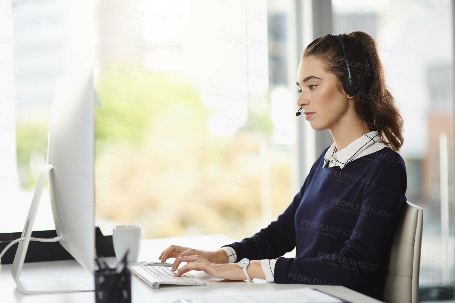 Buy stock photo Business woman, headphones and computer of telesales intern at desk with online consultant in office. Learning, staff and startup with professional and web email with crm, digital work and technology