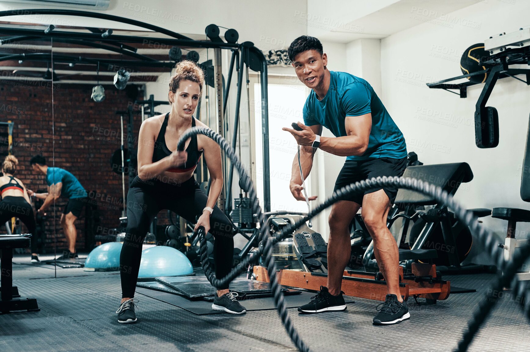 Buy stock photo Fitness, battle ropes and woman in gym, training and personal trainer with timer, energy and sweat. Health club, exercise and endurance for cardiovascular conditioning, people and wellness of workout