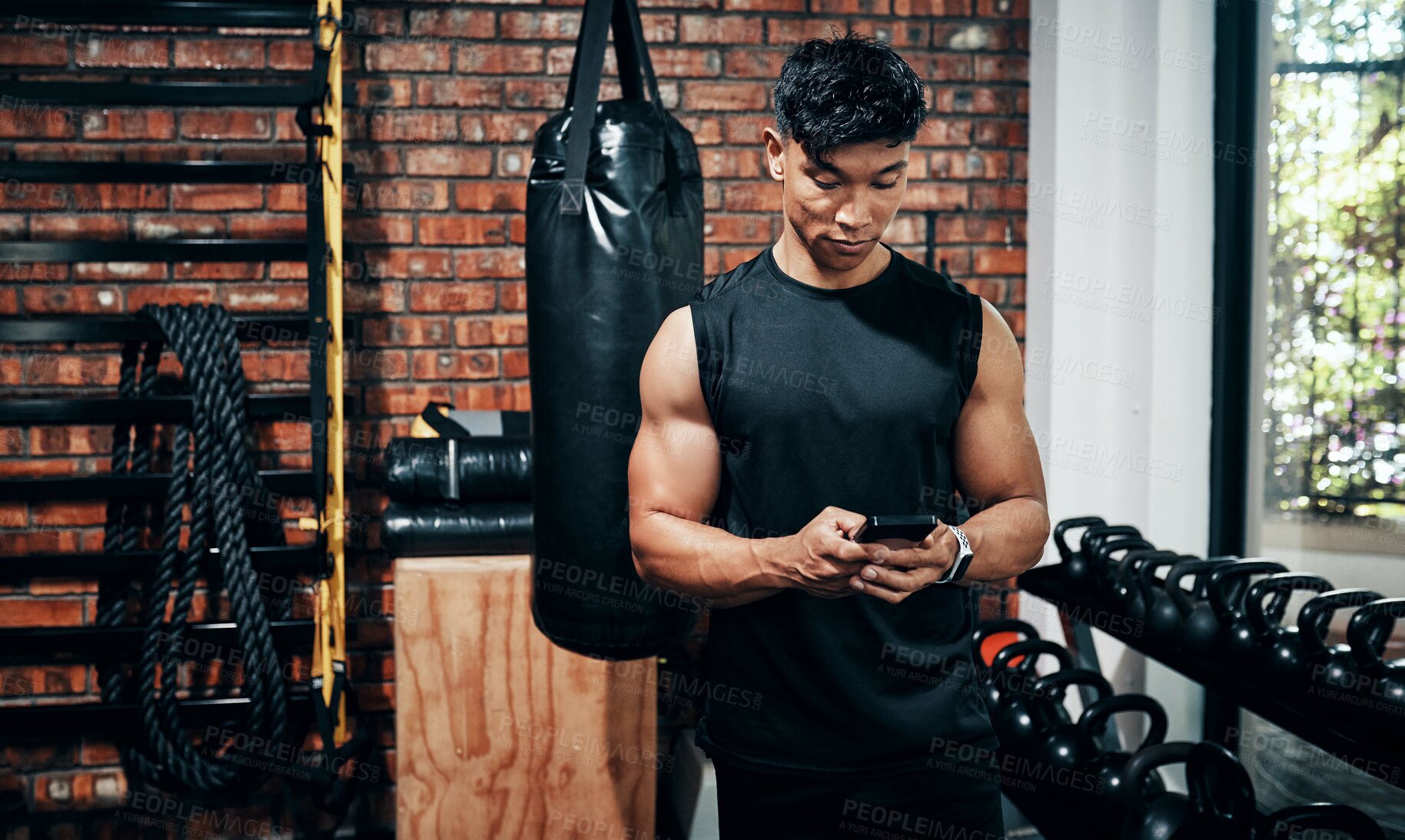 Buy stock photo Fitness, phone and man typing in gym for body health update, training progress or check results on app. Sports club, mobile and athlete with workout schedule, text or reading info for exercise tips