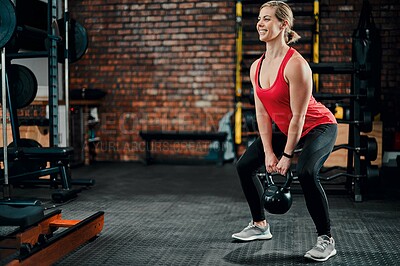 Buy stock photo Kettle bell, woman and gym with smile from workout, weightlifting and training at wellness club. Squats, exercise and happy with strong, power and fitness for health with weights for healthy athlete