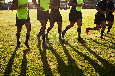 Buy stock photo Sports, people and legs with training for rugby, competition game and practice with warm up for match. Stadium, team and men with running for fitness, stretching and tournament with club by closeup
