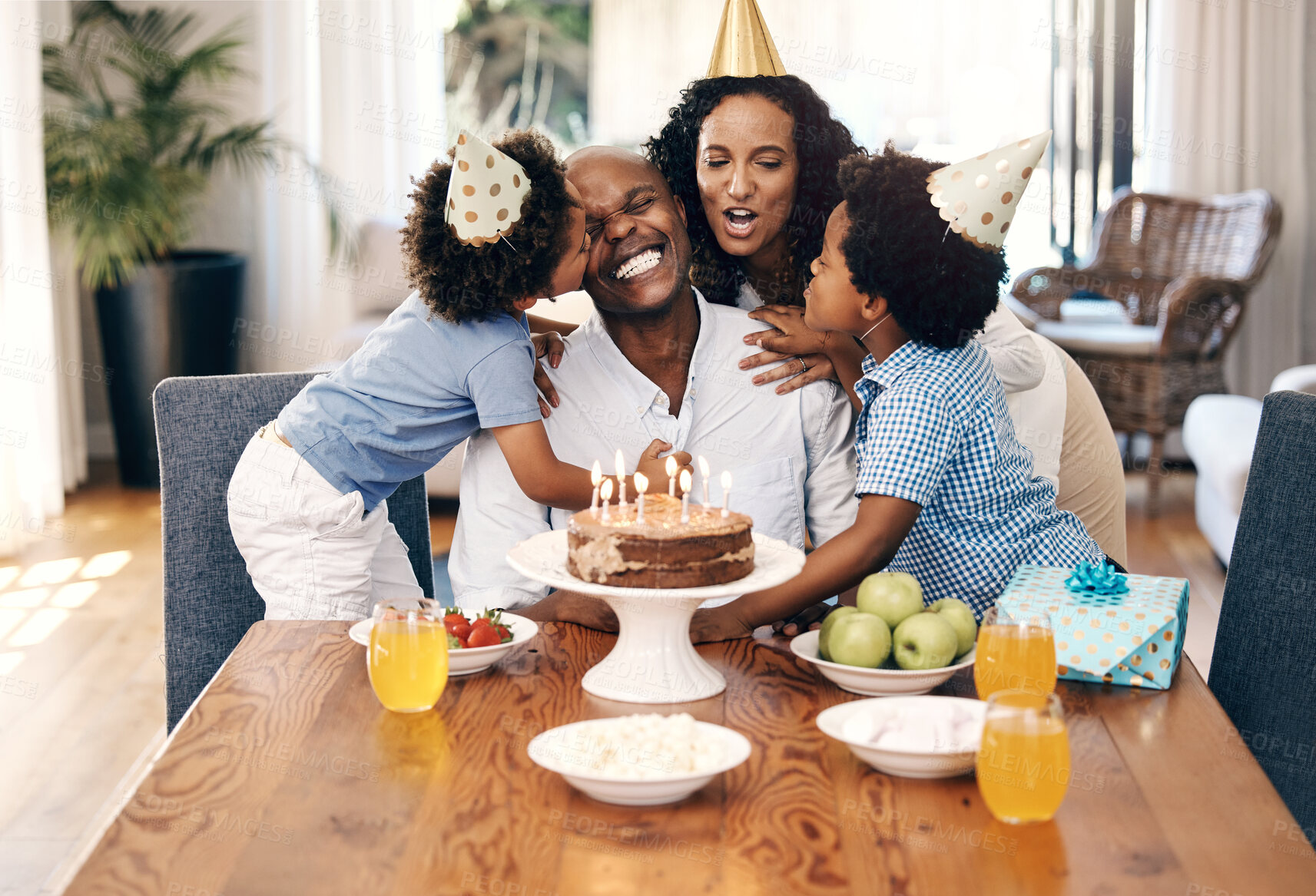 Buy stock photo Cake, love and family at birthday in home for party, event or gathering together for bonding. Happy, connection and children with parents for celebration with hats, gifts and dessert for tradition.