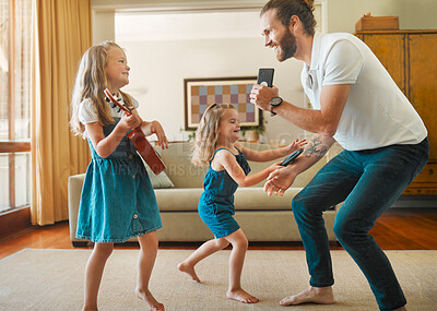 Buy stock photo Guitar, singing and father dancing with children in home for bonding, fun and entertainment. Happy, playing and dad groove with girl kids with string instrument for music together in family house.