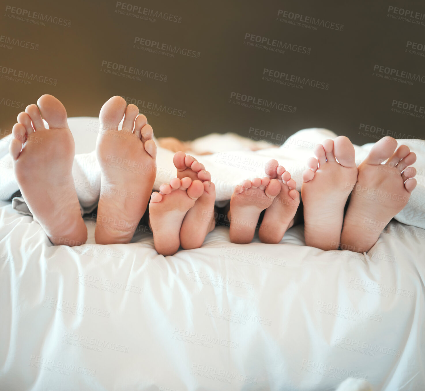 Buy stock photo Feet, relax and sleeping with family in bed together for morning or weekend recovery and rest. Blanket, comfortable  or dreaming with mother, father and sibling children in apartment for bonding