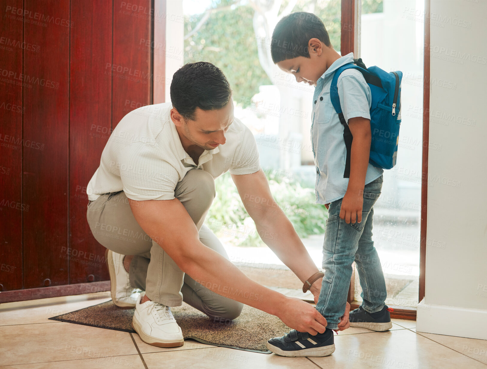 Buy stock photo Father, tying shoes and school with son by door for morning preparation or getting ready at home. Dad, child or tie laces with kid for education, learning journey or first day at preschool at house