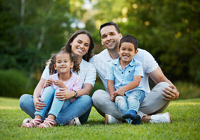 Buy stock photo Happy family, portrait and relax with hug on grass field for bonding, holiday or outdoor weekend together in nature. Mom, dad and children or siblings with smile for fun childhood on lawn at park