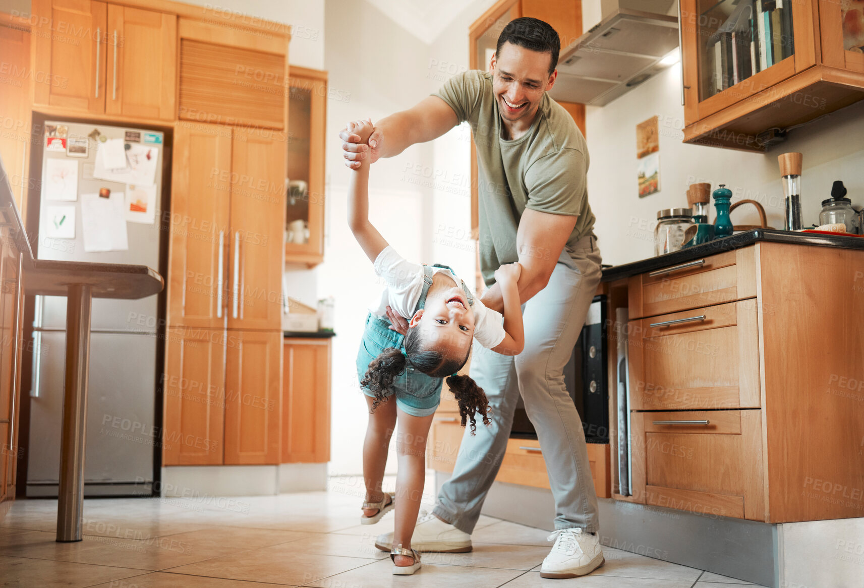 Buy stock photo Happy, father and child dancing in kitchen of playful fun, energy and bonding together of morning routine. Smile, man and girl with family support, movement rhythm and teaching steps of care at house