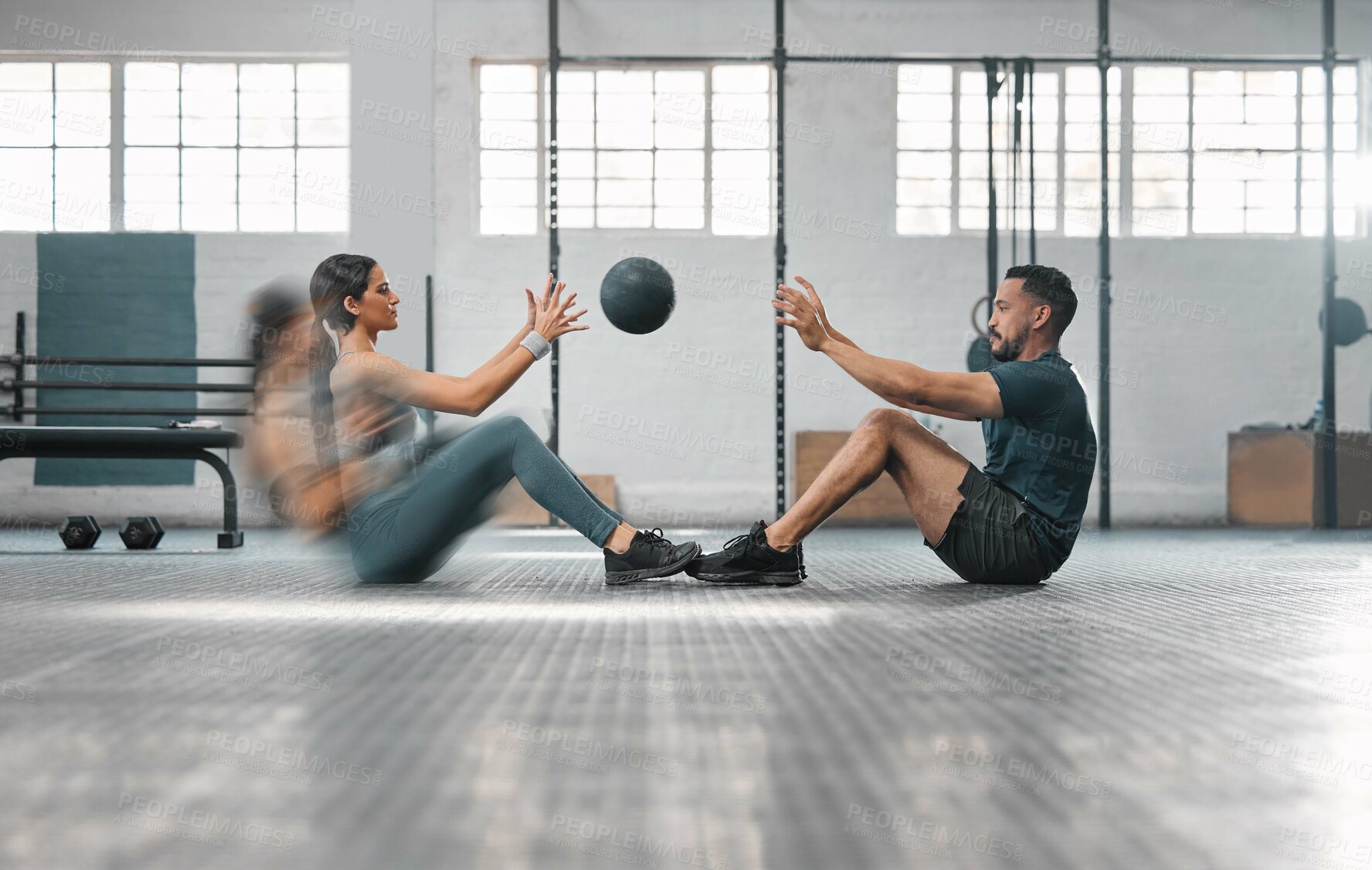 Buy stock photo Active, sporty fitness couple or gym partners training together, doing abs exercises by throwing a weighted slam ball. Male trainer and female athlete in motion focused on workout session or class.