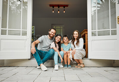 Buy stock photo Parents, children and smile in new home for portrait, real estate opportunity and property investment. Homeowner couple, kids and front door of family house with relax, pride and fresh start in Spain