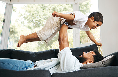 Buy stock photo Dad, son and support flying in home, parent lifting and fun with airplane fantasy in living room. Father, balance child and bonding together by playing games, weekend laughing and love for freedom