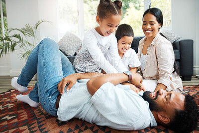 Buy stock photo Parents, children and excited in home with game, tickling fun and bonding on weekend. Couple, kids and happy family on living room floor for relationship development, Fathers Day and playful energy