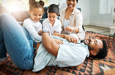 Buy stock photo Parents, kids and happy in home with game, tickling fun and bonding on weekend. Couple, children and excited family on living room floor for relationship development, Fathers Day and playful energy