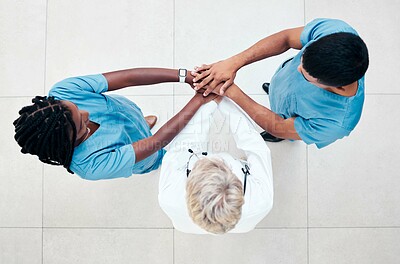 Buy stock photo Support, motivation and doctors with hands stacked for healthcare, medical work and teamwork in surgery. Celebration, community and workers of medicine with a goal, communication and trust from above