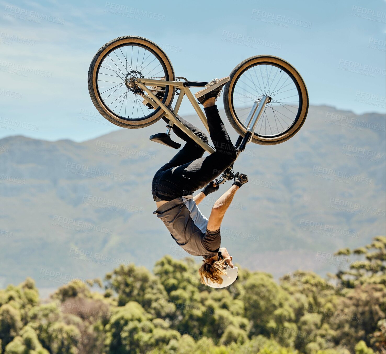 Buy stock photo Mountain bike, man and upside down air jump, action and bicycle stunt, challenge and adventure, freedom or dynamic risk in sky. Biker athlete, sports adrenaline and energy in outdoor competition show