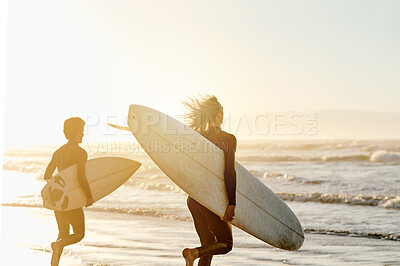 Buy stock photo Sunset, enjoying and friends at the beach with surfboards for a hobby, waves and learning an activity. Calm, training and men in the water by the ocean for surfing, competition and sports in the sea