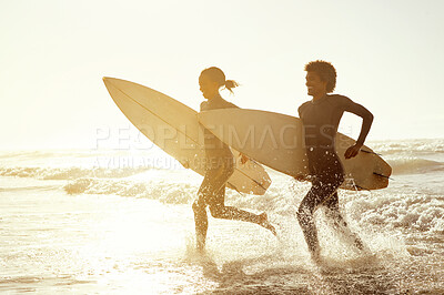 Buy stock photo Sunset, running and couple on the beach with surfboards to practice surfing while on vacation. Nature, sports and young man and woman surfers in the ocean or sea while on a tropical holiday in Hawaii