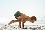 Man, crow pose and yoga at beach with stretching, muscle and wellness on sand with mindset for health. Male, training and balance for development, peace or mindfulness by ocean for exercise in summer
