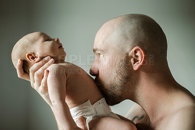 Buy stock photo Face, family and baby with a father kissing his child in studio on a gray background for love or care. Kiss, kids or together and a man bonding with his newborn infant through skin contact