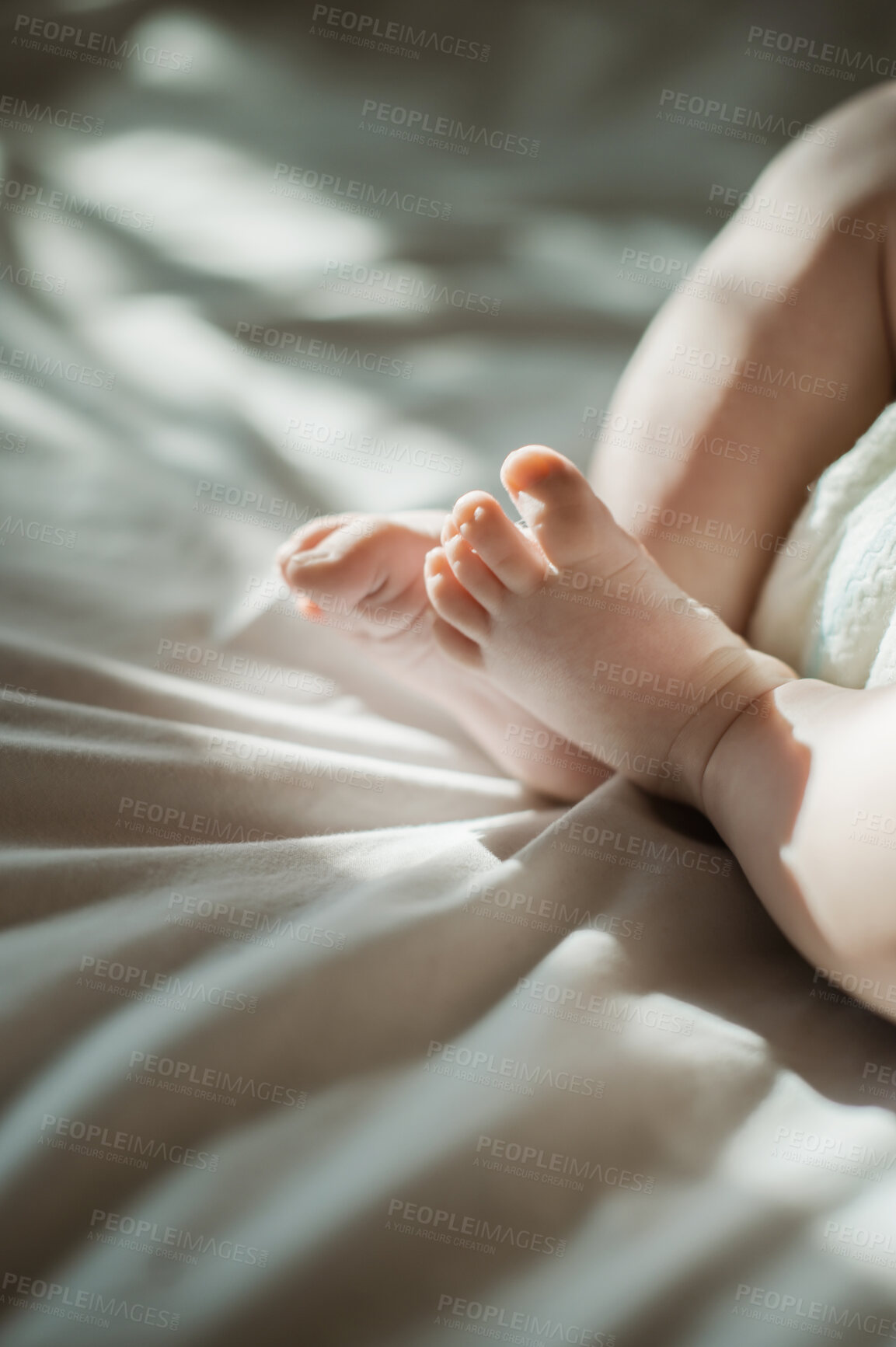 Buy stock photo Baby, feet and infant relax lying on a bed in a bedroom with sun, sunlight or sunshine in the morning. Sunrise, child and newborn kid calm with cute and adorable toes in a home or house nursery