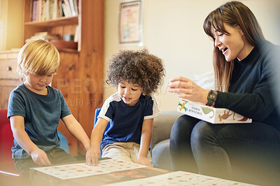 Buy stock photo Teacher, child and learning with puzzle in kindergarten, diversity and mind development with smile in class. Woman, boy kids or teaching game for problem solving, pattern or education in classroom