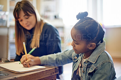 Buy stock photo Education, writing and teacher with a girl in a classroom for learning, studying and creativity. Help, homework and African student with a woman drawing in a book for support, teaching and lesson