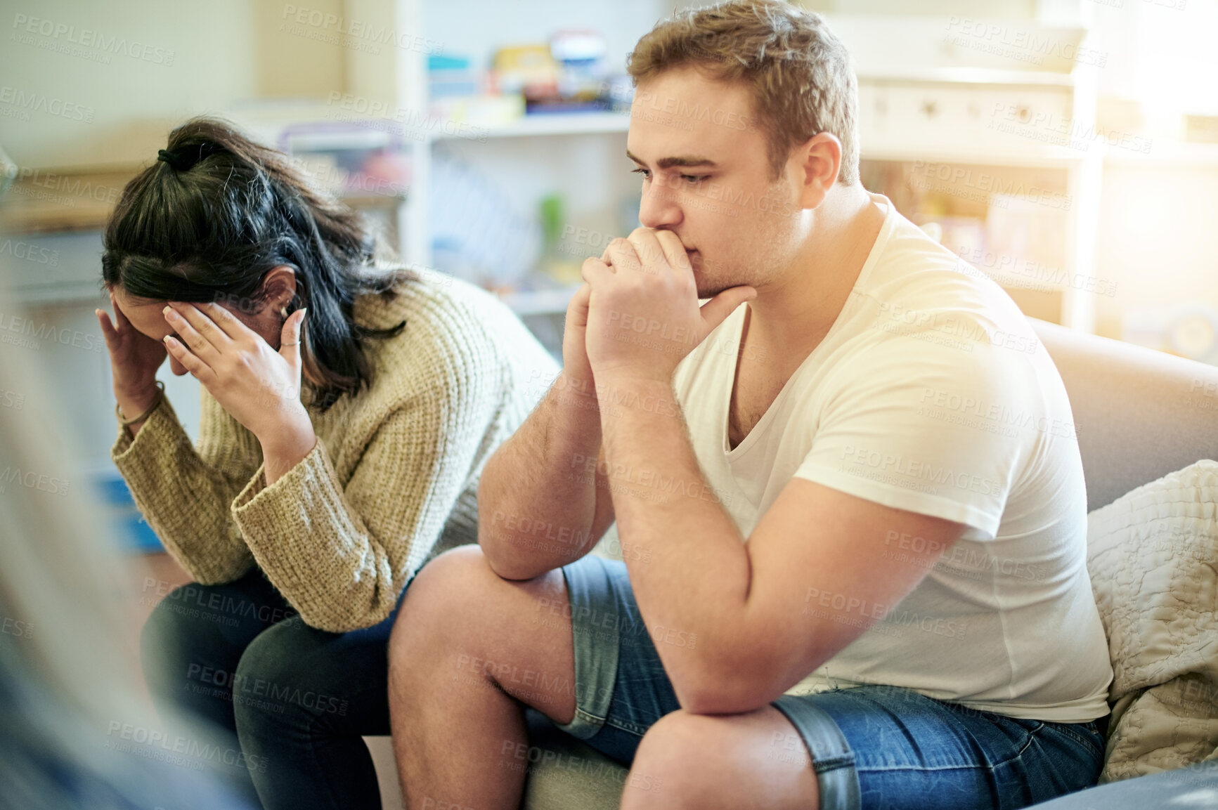 Buy stock photo Conflict, upset and couple fighting on a sofa for toxic, cheating or relationship breakup. Upset, problem and frustrated young man and woman in an argument together in the living room of their home.