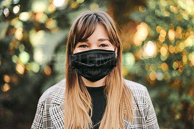 Buy stock photo Woman, portrait and face mask outdoor with bokeh light in nature, safety and covid wellness gear. Pandemic, corona and protection masks for healthy young female in fresh air with coronavirus recovery