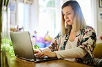 Laptop, typing and woman in home office for email, project or online browsing in house. Freelancer, remote worker and person or professional with computer for research, writing and web scrolling.