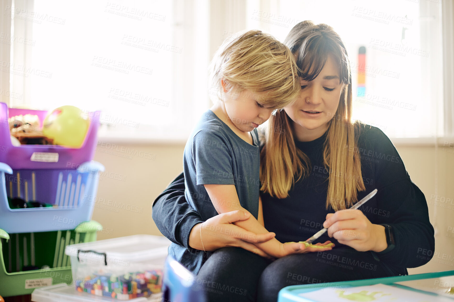 Buy stock photo Mother, child and painting hand in home, playing and bonding together in house. Care, art education and mama paint fingers and palm of learning boy for creativity, having fun or enjoying quality time