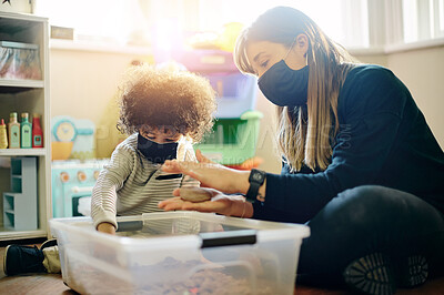 Buy stock photo Covid, education or toys with a mother and son in a playroom together for learning or child development. Children, family or school with a woman teaching motor skills to a student boy during lockdown