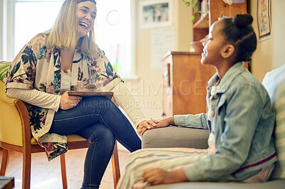 Buy stock photo Girl child, therapist and talk for mental health with psychology expert, woman or laughing with support. Comic childhood psychologist, consultation or guidance counselor at school with holding hands