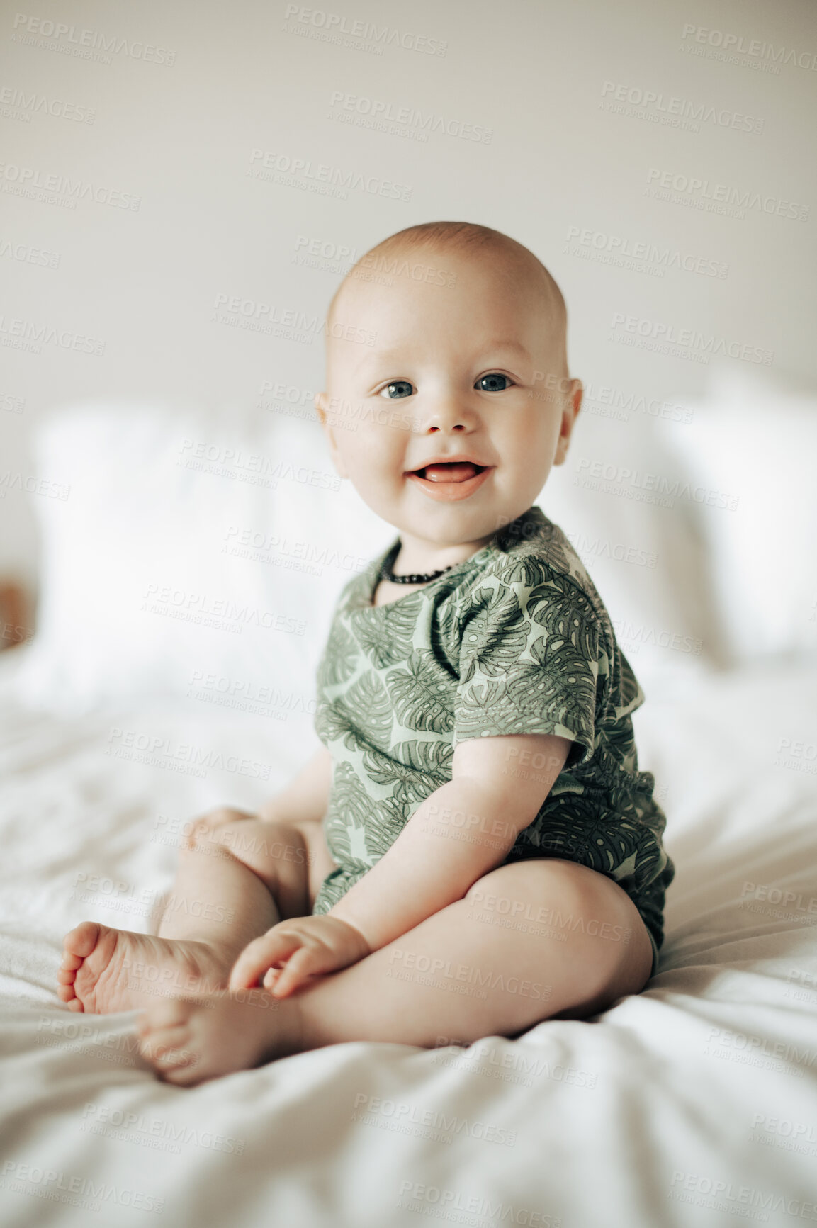 Buy stock photo Cute, adorable and portrait of a baby boy on a bed sitting and playing in his modern nursery at home. Happy, smile and sweet infant child being playful while in his bedroom at a house or apartment.