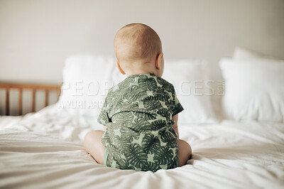 Buy stock photo Baby, back view and infant sitting on a bed in a bedroom relax in development in as home or house being cute and curious. Toddler, child or kid in a nursery relaxing enjoying childhood and playing