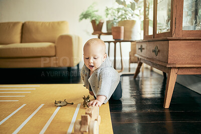 Buy stock photo Baby, toys and child play in home, having fun and learning, relaxing or growth. Development, childhood and kid, newborn or toddler playing with sustainable wooden car and enjoying time in house alone