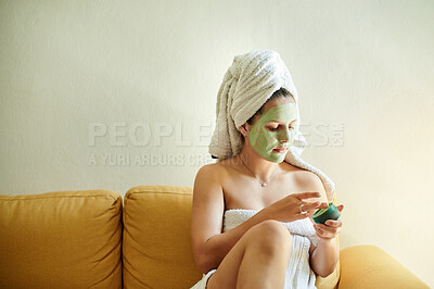 Buy stock photo Skincare, beauty and woman using cosmetic product on her face as a treatment, facial and self care in her home or house. Detox, mask and female cleaning her skin for morning routine while she relax