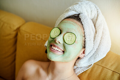 Buy stock photo Facial, beauty and happy woman with cucumber on eyes or face for vitamin c, wellness and dermatology lying on a couch or sofa. Relax, mask and skincare of a female doing natural cosmetics in a home