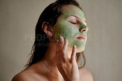 Buy stock photo Face, beauty and woman using cosmetic product as facial treatment, skincare and self care isolated in a studio background. Detox, mask and female cleaning her skin for morning routine and eyes closed