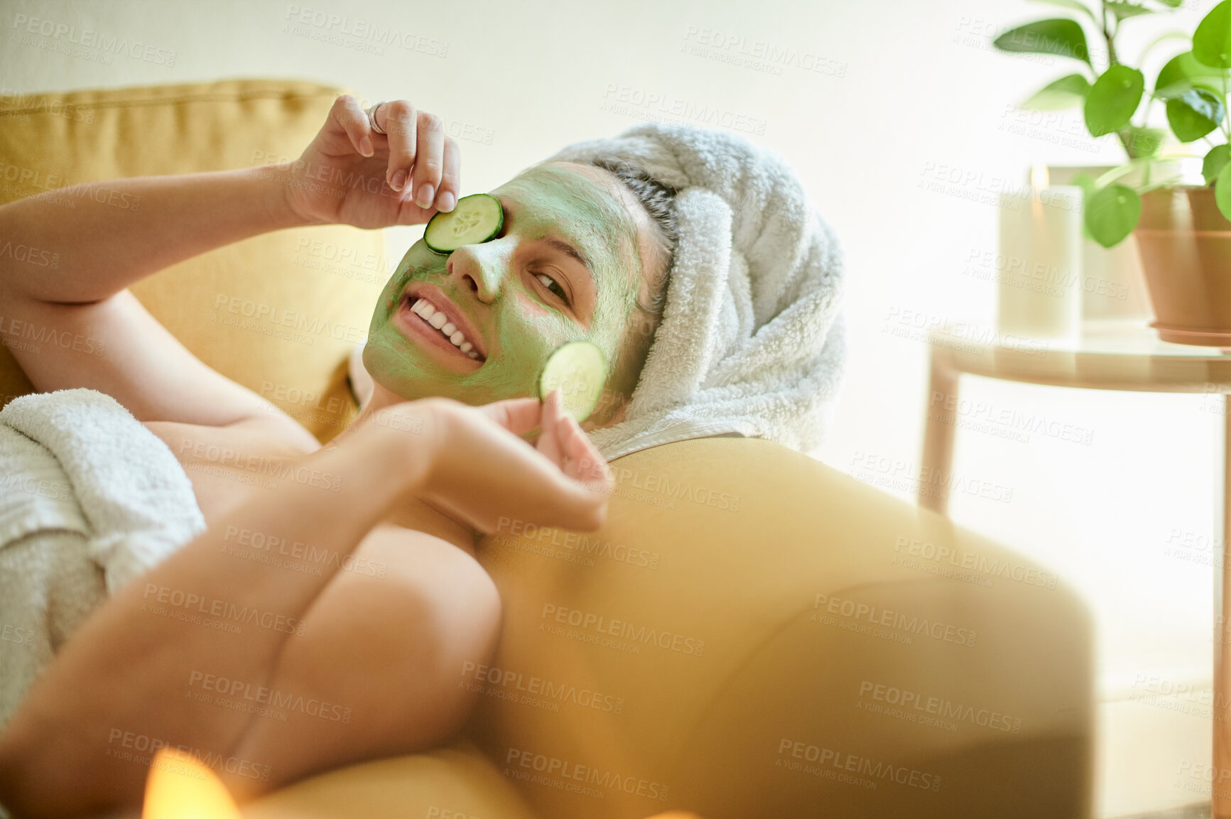 Buy stock photo Facial, treatment and woman with cucumber on eyes or face for vitamin c, wellness and natural beauty lying on a couch or sofa. Relax, spa and portrait of happy female using vegetable to detox
