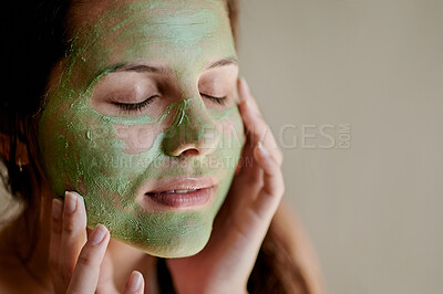 Buy stock photo Facial, beauty and woman using cosmetic product on her face for treatment, skincare and self care in a studio background. Detox, mask and female cleaning her skin for morning routine while she relax