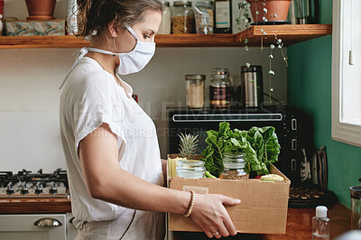 Buy stock photo Mask, kitchen and woman grocery delivery from online shopping service with covid regulations for safety. Food, health and person with fresh organic groceries in box from supermarket during pandemic.