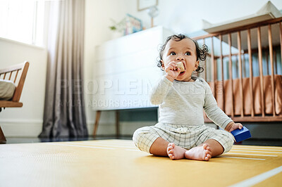 Buy stock photo Child development, toys and a baby sitting on the floor in it's bedroom at home while playing or looking curious. Children, learning and growth with an adorable little girl kid in a house to play