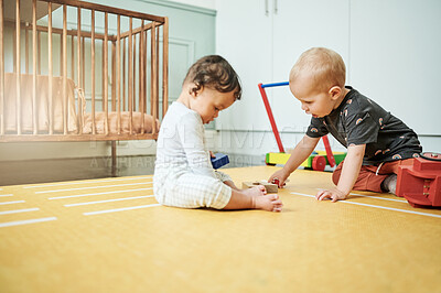 Buy stock photo Babies playing, home and kid toys for mobility development and learning together in a bedroom. Nursery, toy brick and cute children curious about building blocks and activity in a house on the floor