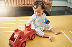Toy truck, baby and play in home, having fun and relaxing in nursery of house top view. Development, childhood and playful, carefree and kid, infant or newborn playing with block, red car or learning