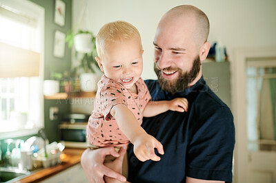 Buy stock photo Father, baby and parent playing with a child in a kitchen at home laughing, smile an feeling happy together. Bonding, single dad and man person showing kid happiness, care and support as way of love